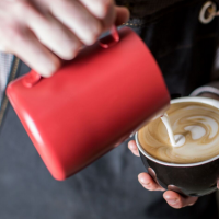 Red Non-Stick Milk Frothing Jug in use